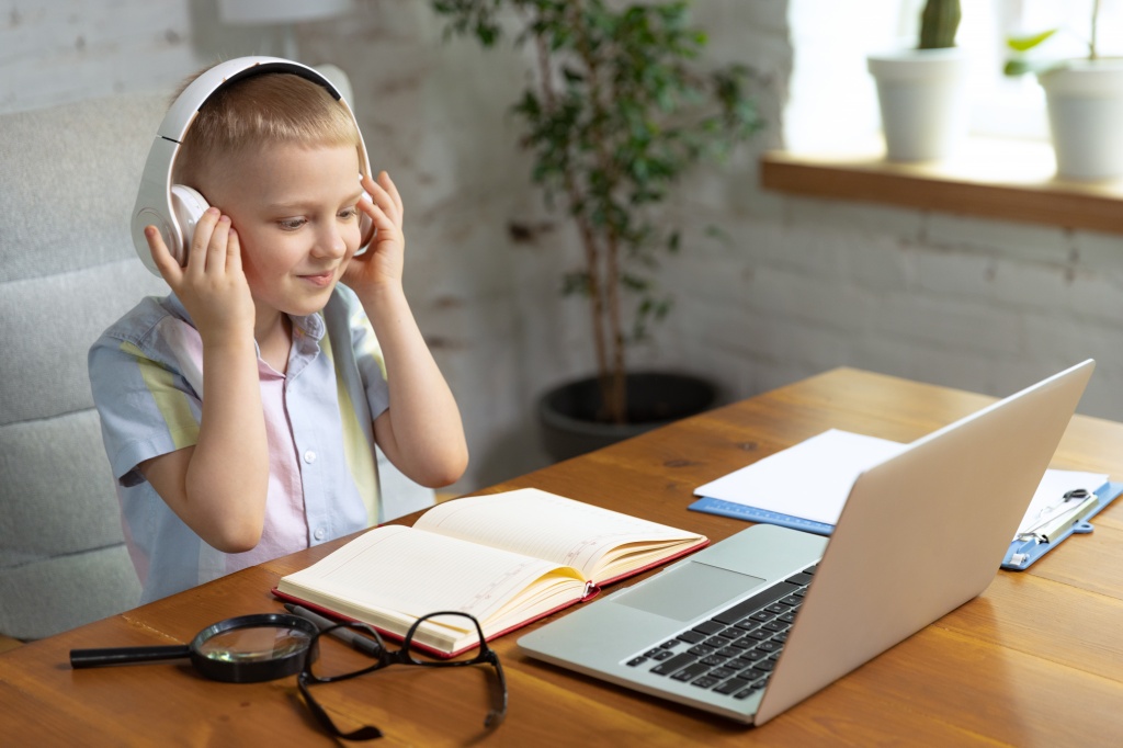 portrait-of-little-boy-child-in-headphones-studying-at-home-looking-on-laptop-working-with-teacher-online-education.jpg
